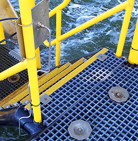 Yellow DeltaRail fiberglass handrail system with blue square mesh grating 