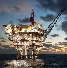 Oil platform in Gulf of Mexico at sunset