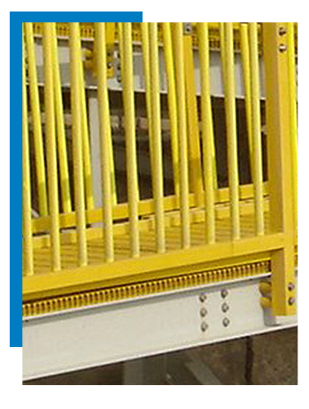 Yellow fiberglass handrail system mounted on a public beach access ramp